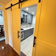 We-Transformed-a-tiny-Galley-Kitchen-in-Astoria-Queens-using-Barn-doors-to-create-more-of-an-open-concept 0